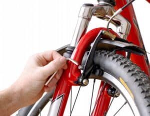 cyclist-adjusting-bike-rim-brake-300x233-6634517