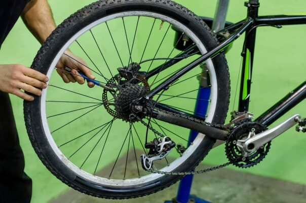 man-adjusting-bike-disc-brakes-2990389